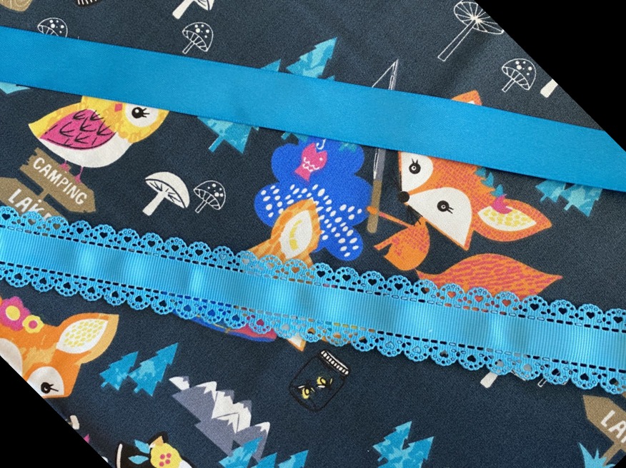 Cotton fabric black with bright fox, blue ribbon trim